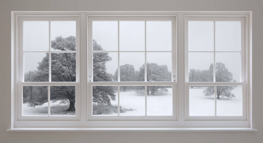 Winter Snow Through Window of Warm Home
