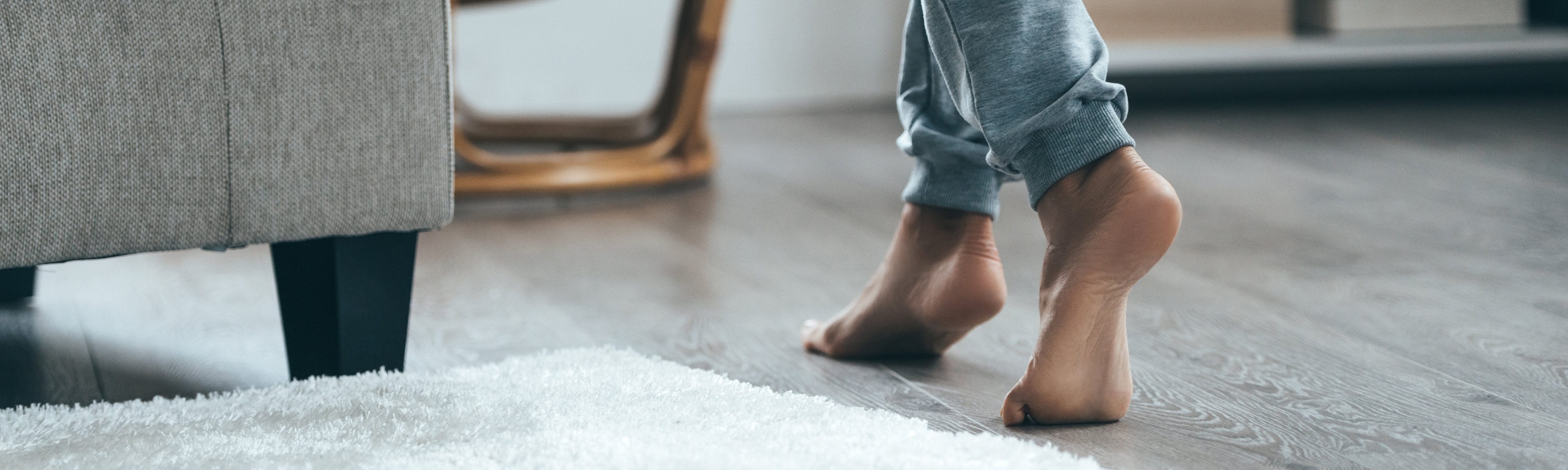 Woman walking barefoot on a warm floor.