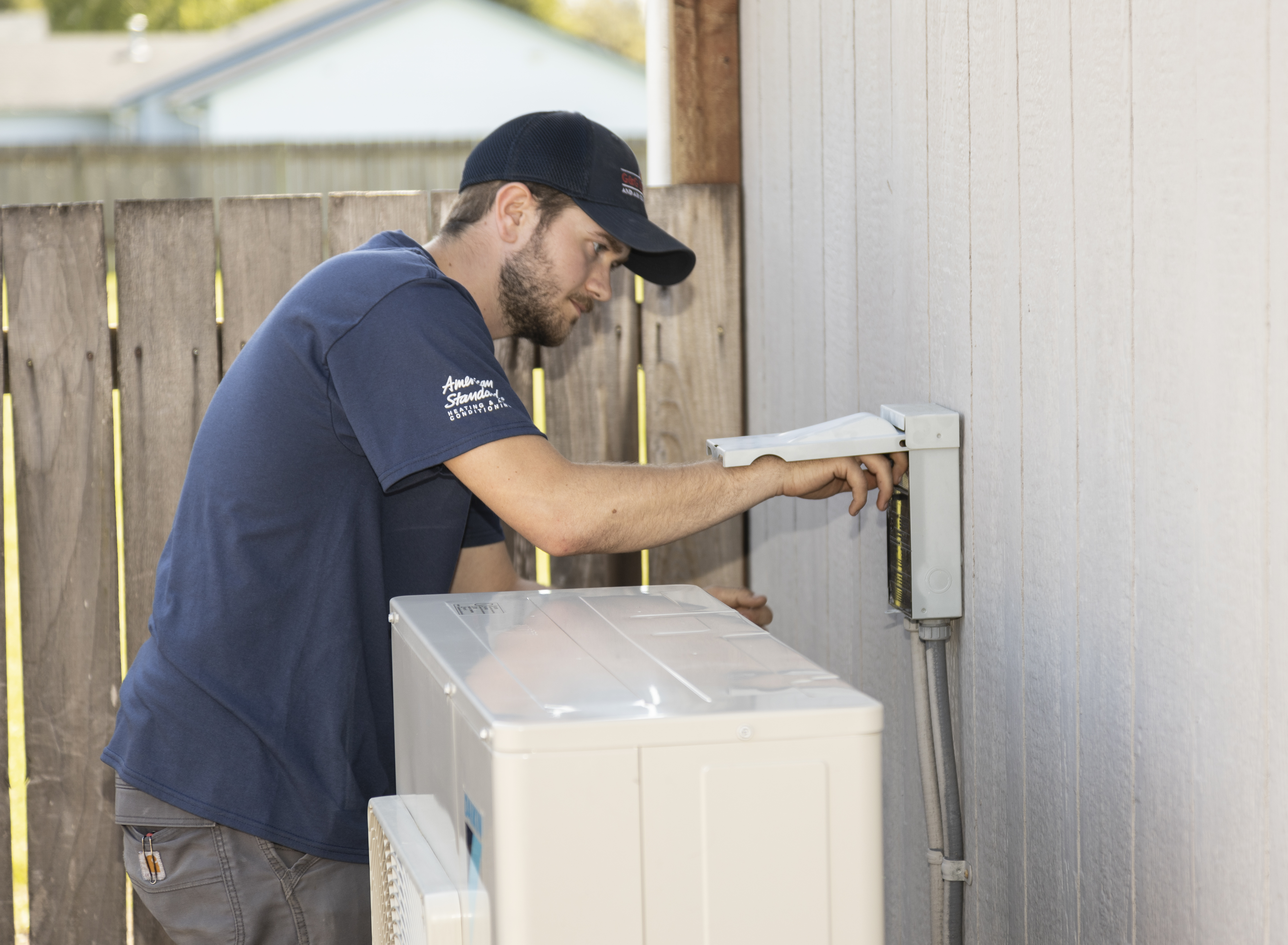 HVAC tech working on heat pump