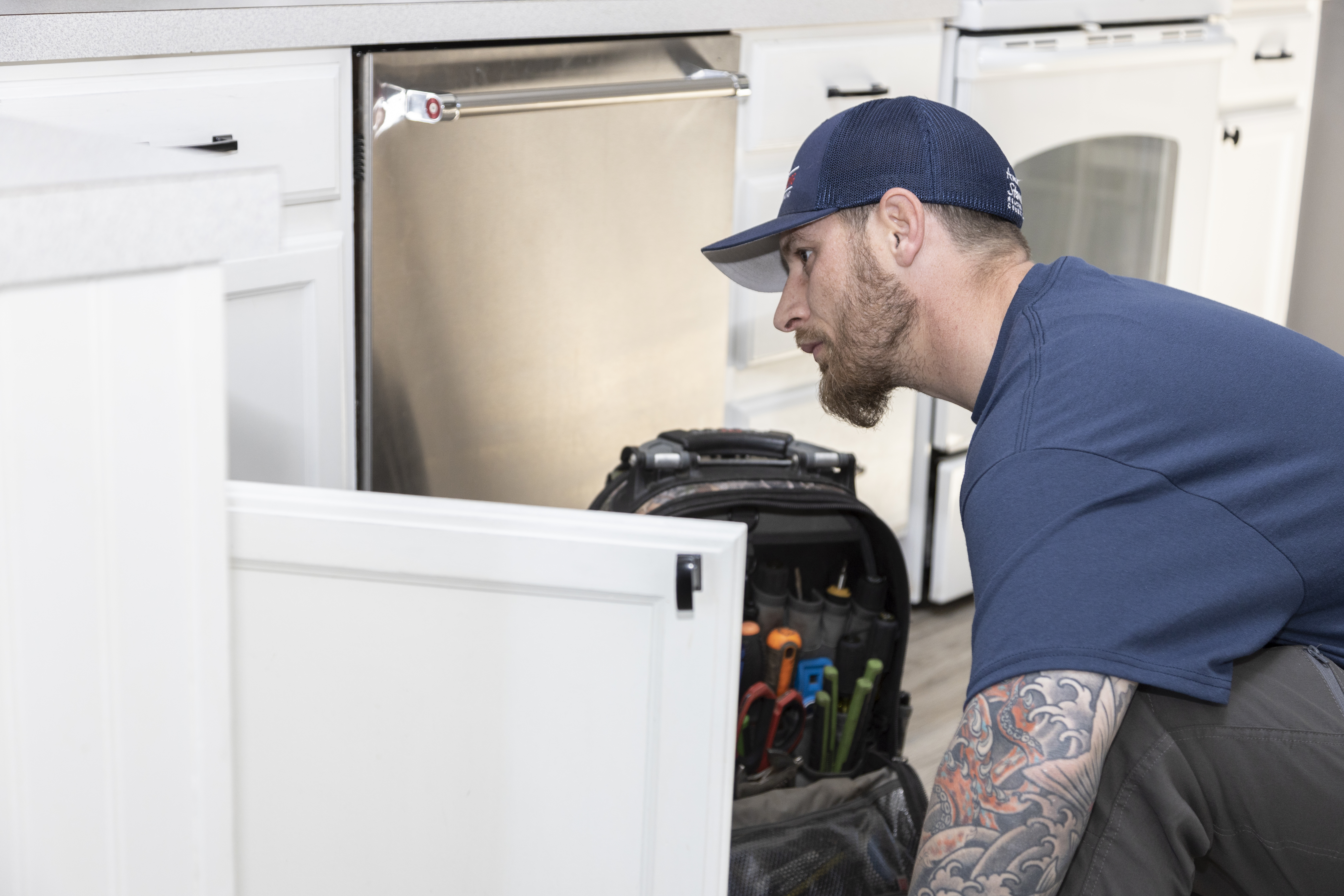plumber working on kitchen plumbing