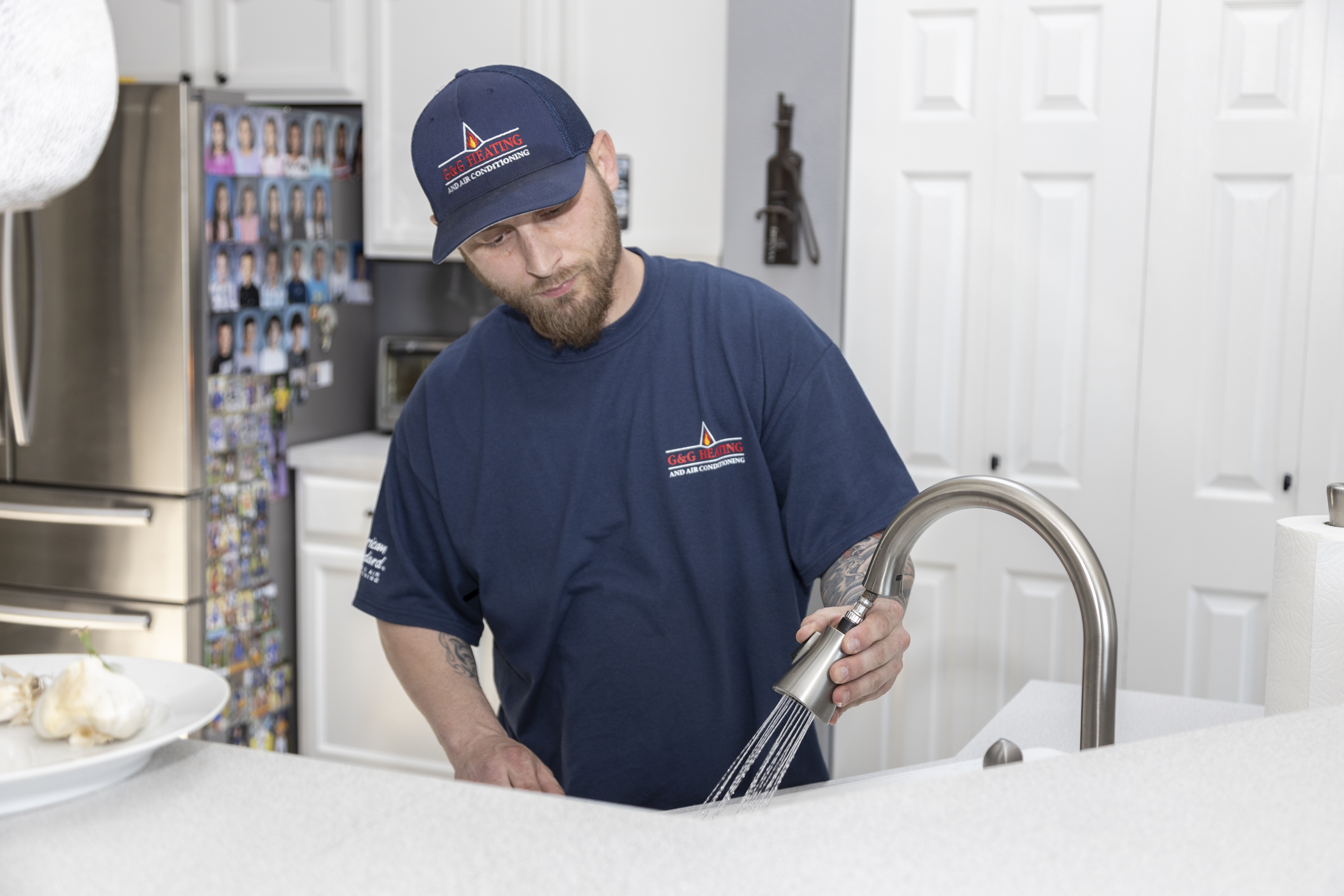 Drain Cleaning 1 plumber working on kitchen faucet
