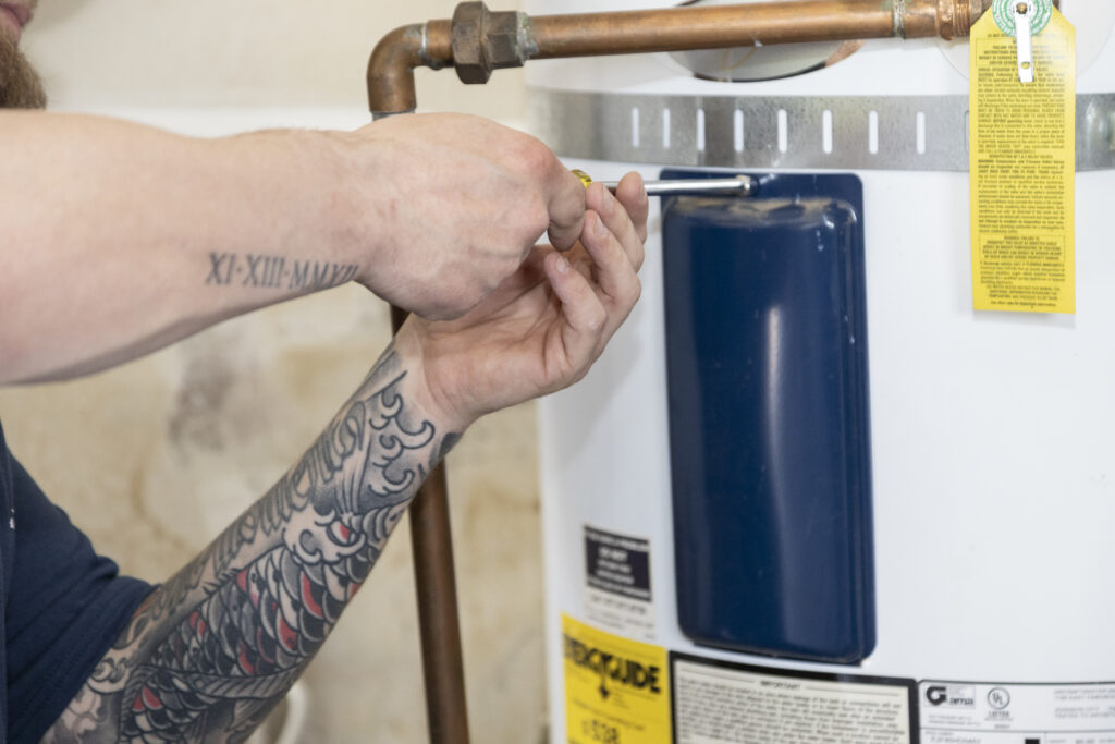 plumber fixing hot water heater