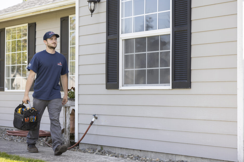 Tumwater HVAC tech walking to customer house